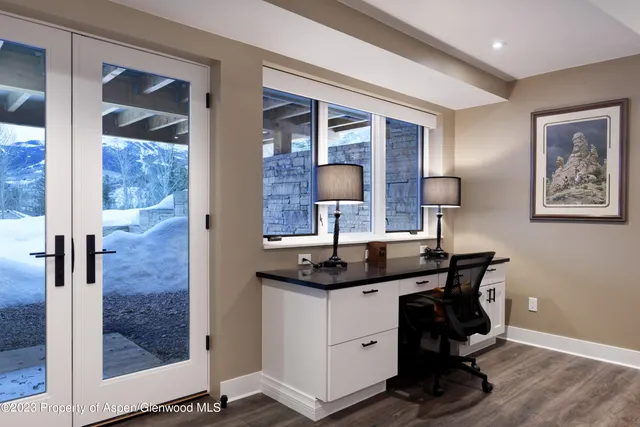 a bathroom with a granite countertop sink a mirror and shower