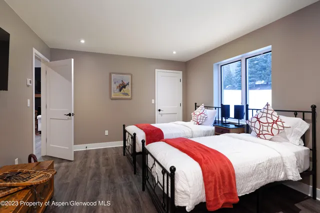 a bedroom with two beds and a window