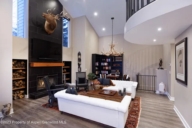 a living room with furniture a fireplace and a flat screen tv