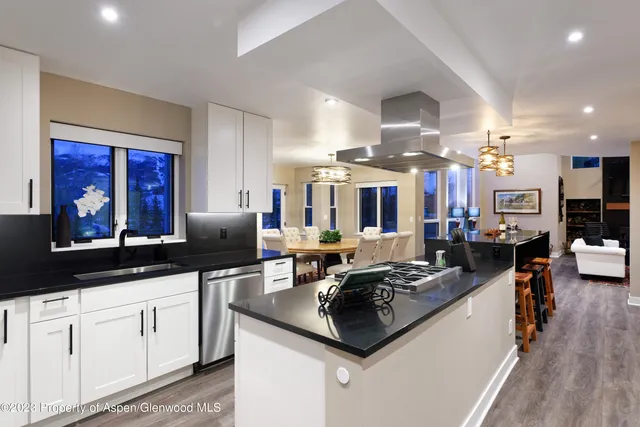 a kitchen with stainless steel appliances granite countertop a stove and a sink