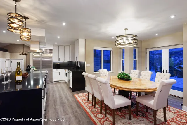 a view of a dining room with furniture and chandelier