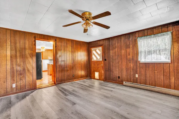 wooden floor in an empty room with a window