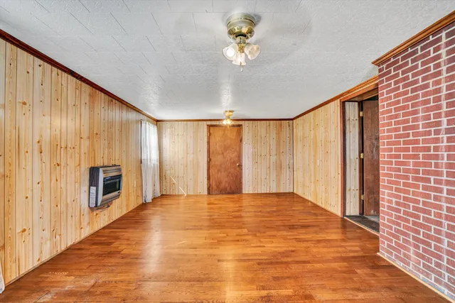 a view of an empty room with a fireplace and a window