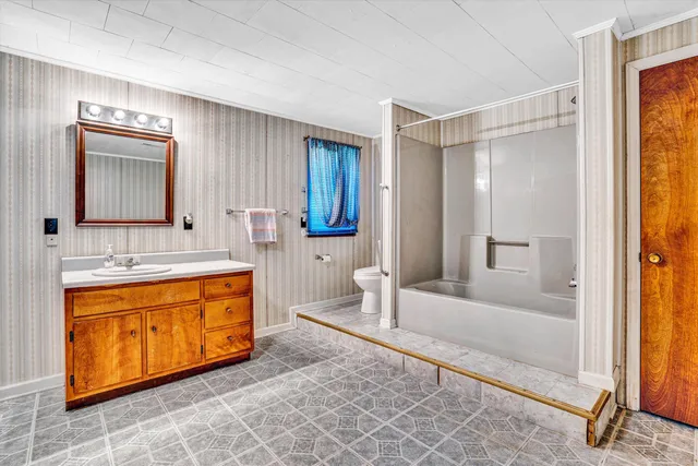 a spacious bathroom with a tub sink and mirror