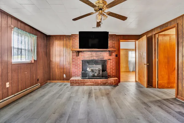 a living room with fireplace furniture and a flat screen tv