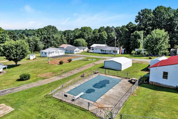 a view of a house with swimming pool and yard