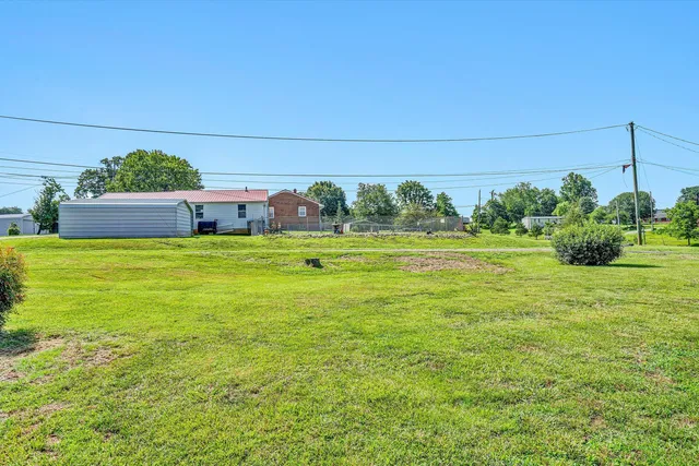 a view of a pool with an outdoor space and seating area