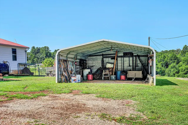 a view of a house with a yard and sitting area