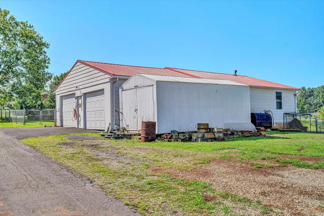 a backyard of a house with potted plants and large trees