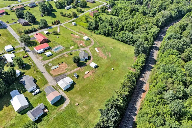 an aerial view of residential houses with yard