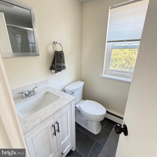 222 East Montgomery Avenue, Unit 207 Ardmore, PA 19003 - Photo 12 of 14 a bathroom with a granite countertop toilet sink and mirror