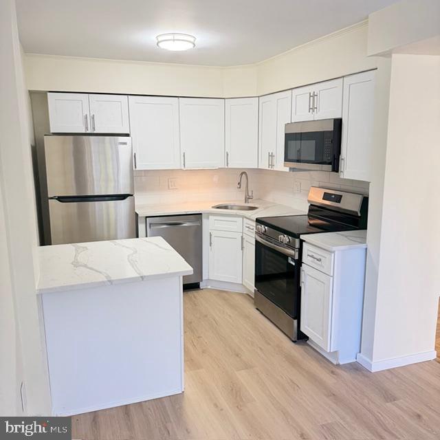 222 East Montgomery Avenue, Unit 207 Ardmore, PA 19003 - Photo 5 of 14 a kitchen with stainless steel appliances a stove refrigerator sink and microwave