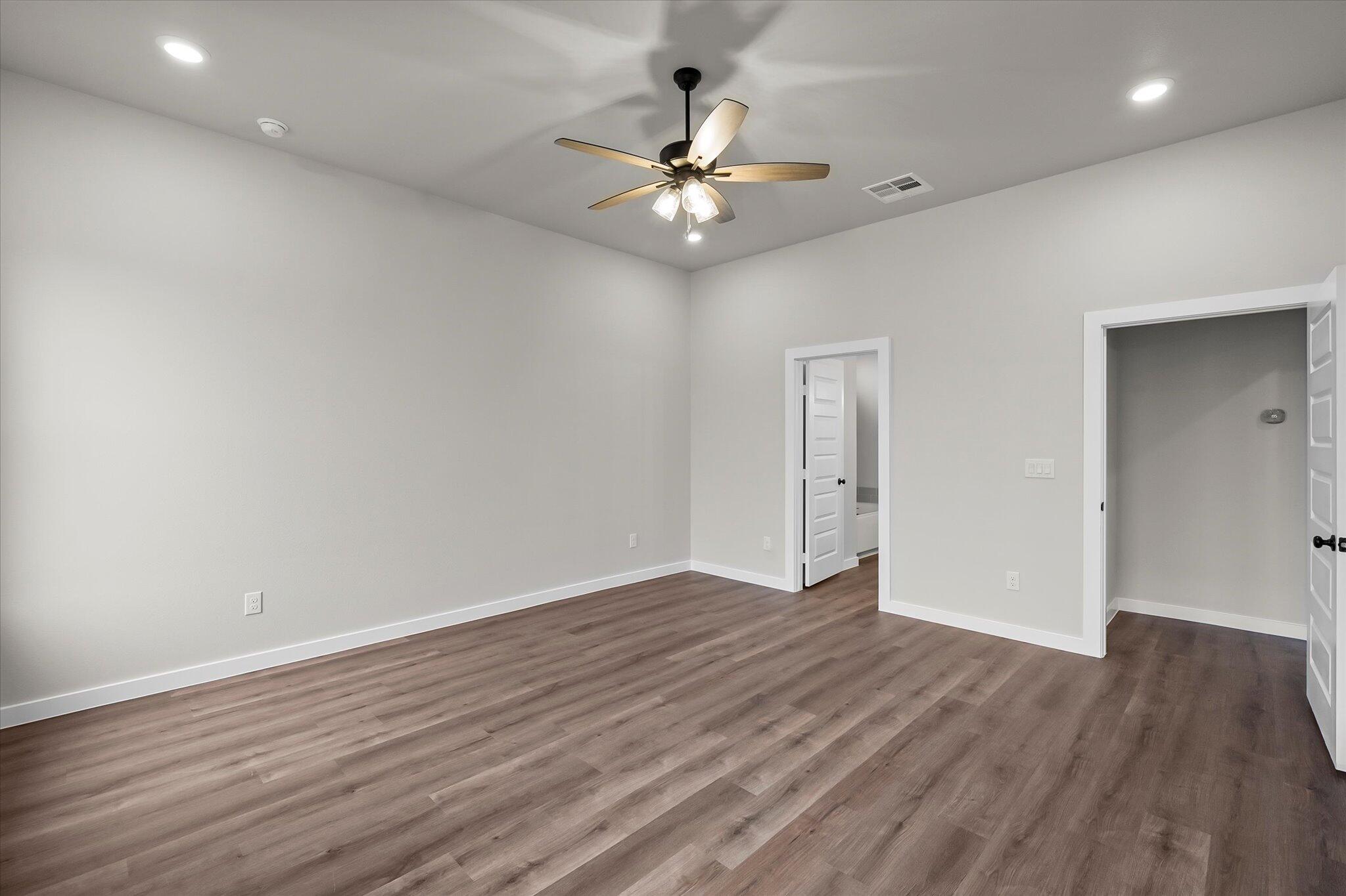 7436 30th Street Lubbock, TX 79407 - Photo 14 of 25 a view of an empty room with wooden floor
