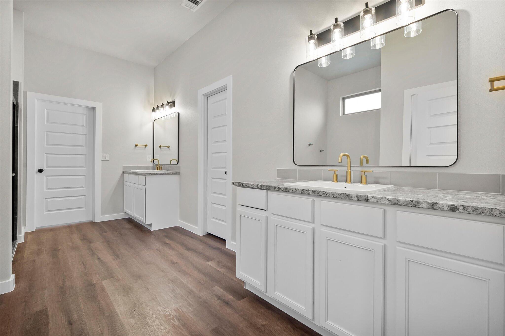 7436 30th Street Lubbock, TX 79407 - Photo 15 of 25 a bathroom with a sink and a mirror