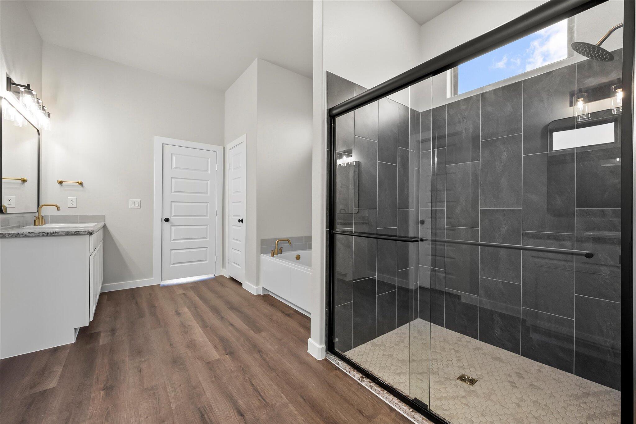 7436 30th Street Lubbock, TX 79407 - Photo 16 of 25 a bathroom with a sink mirror and shower