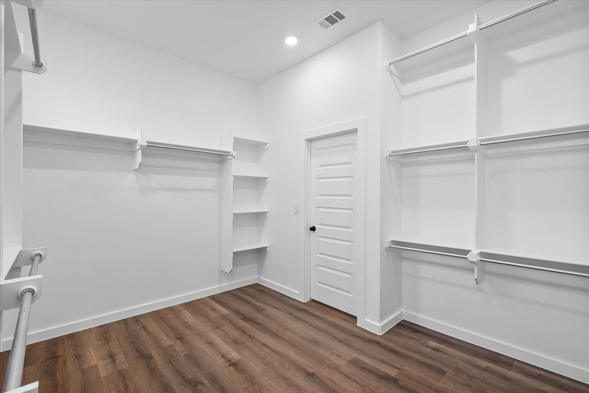 7436 30th Street Lubbock, TX 79407 - Photo 18 of 25 a view of walk in closet with empty racks