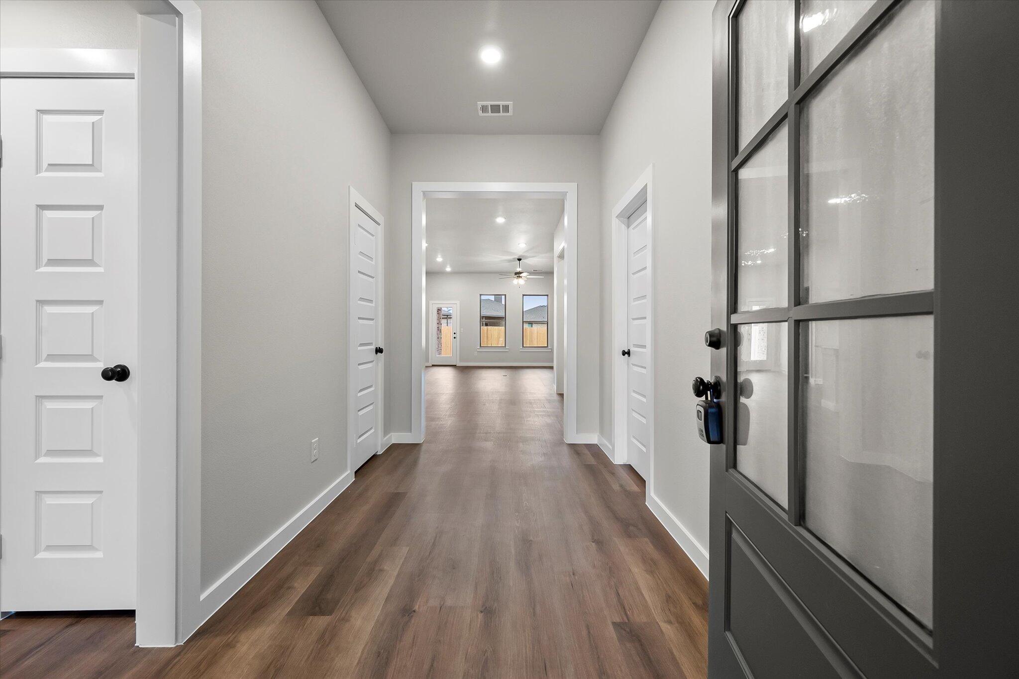 7436 30th Street Lubbock, TX 79407 - Photo 2 of 25 a view of a hallway with wooden floor and staircase