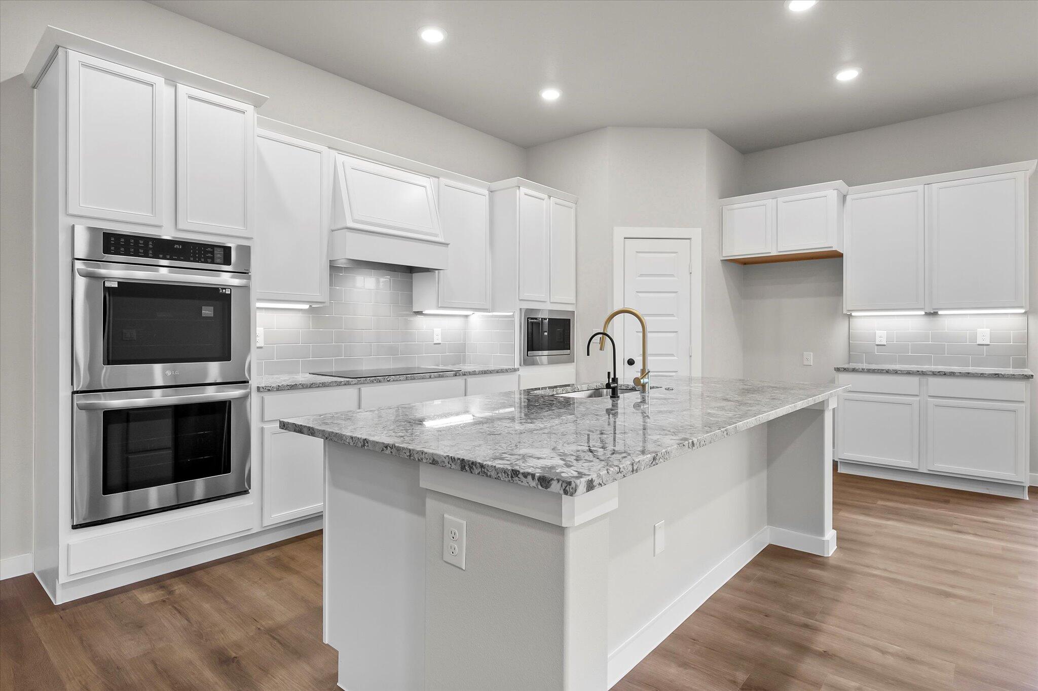 7436 30th Street Lubbock, TX 79407 - Photo 5 of 25 a kitchen with stainless steel appliances granite countertop a sink stove and cabinets