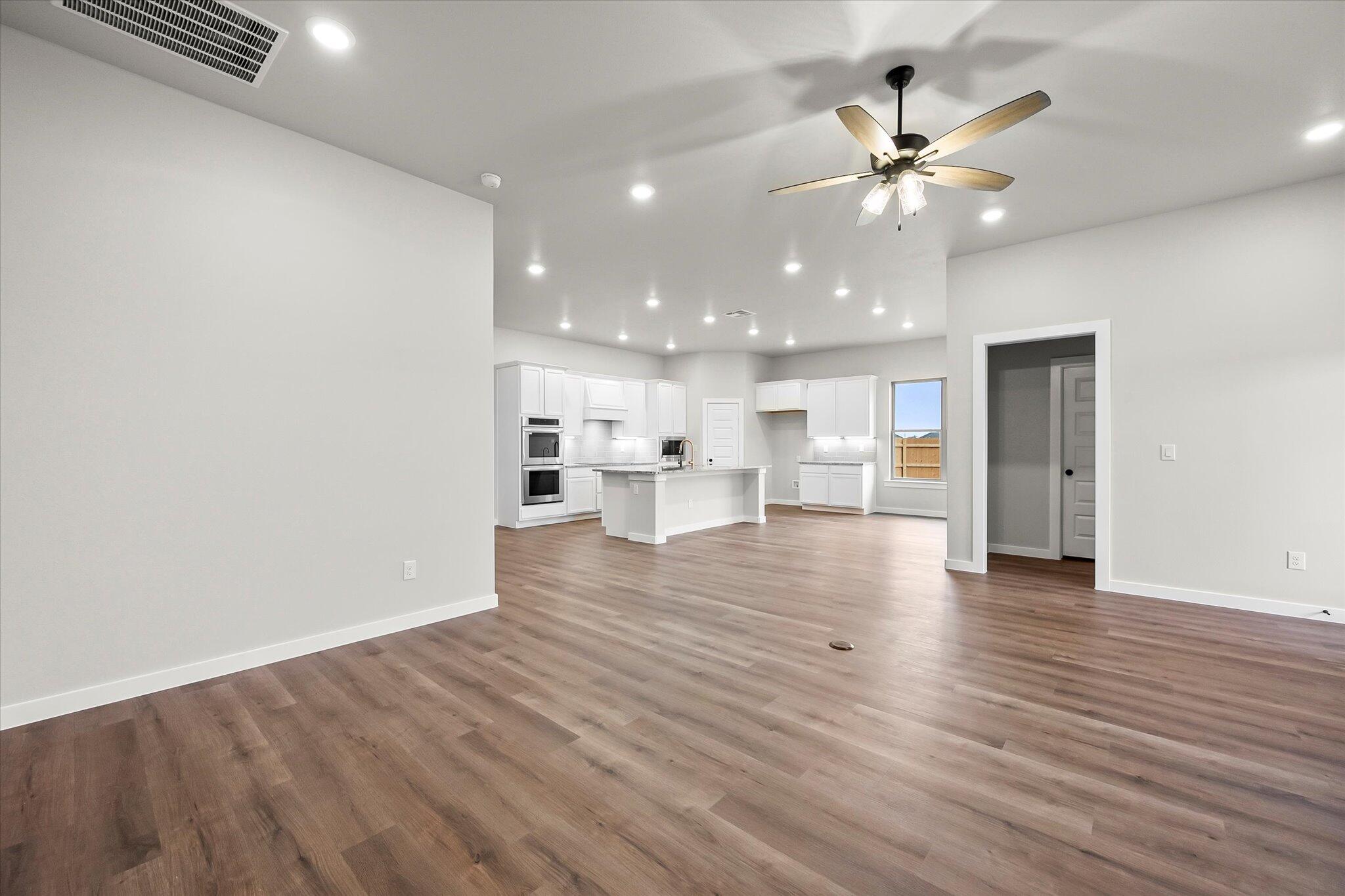 7436 30th Street Lubbock, TX 79407 - Photo 9 of 25 a view of a living room a wooden floor and kitchen