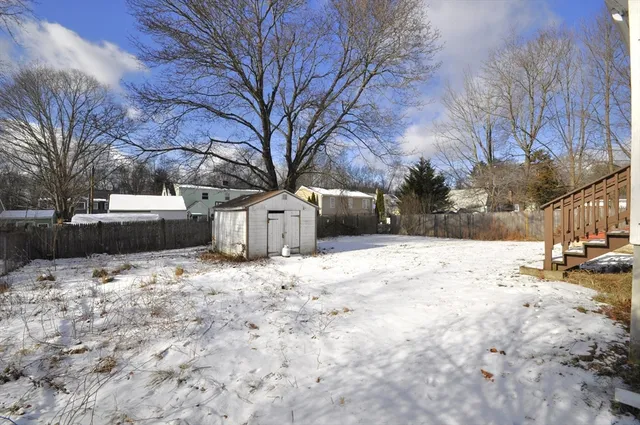 a front view of a house with a yard covered in snow