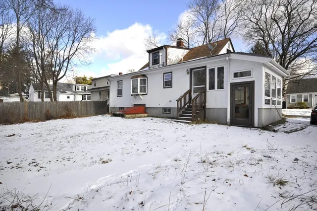 a view of a white house covered with snow in front of house