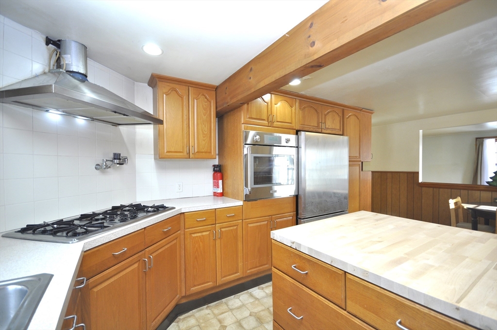 34 Guild Road Brockton, MA 02302 - Photo 2 of 22 a kitchen with a stove a sink and a refrigerator