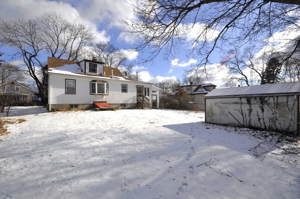 34 Guild Road Brockton, MA 02302 - Photo 21 of 22 a view of a white house covered with snow in front of house
