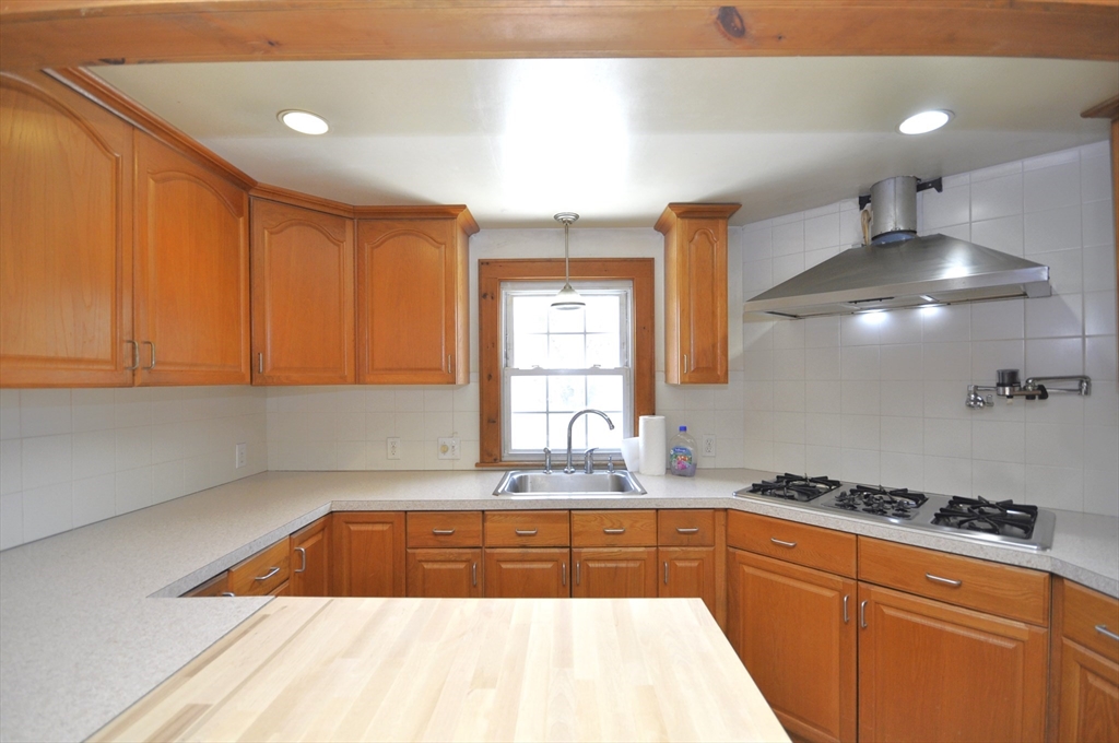 34 Guild Road Brockton, MA 02302 - Photo 3 of 22 a kitchen with granite countertop a sink a stove and cabinets