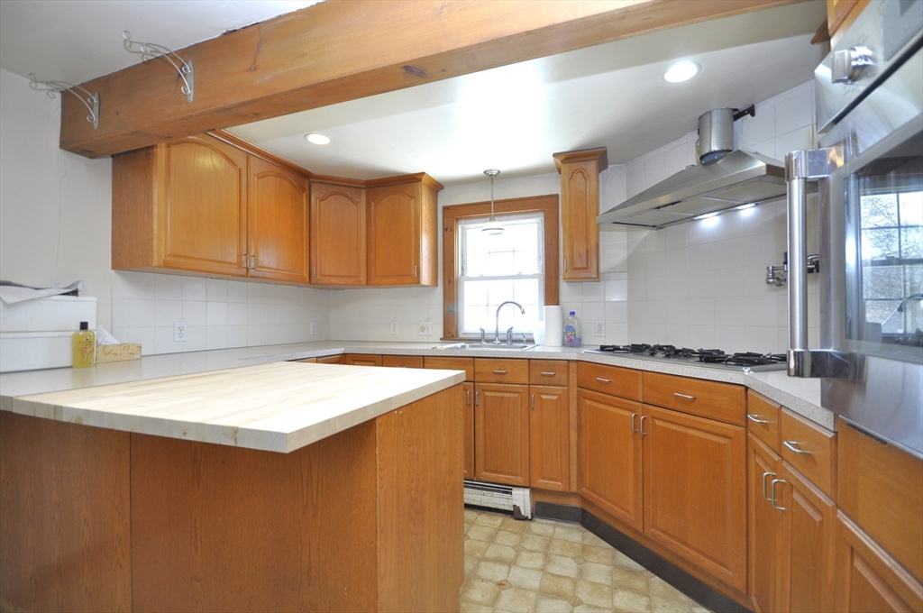 34 Guild Road Brockton, MA 02302 - Photo 5 of 22 a kitchen with stainless steel appliances granite countertop a sink a stove and a refrigerator