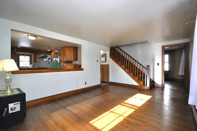 a view of a hallway with wooden floor and stairs