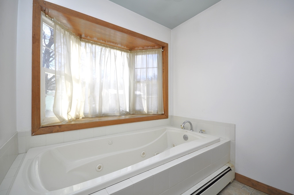 34 Guild Road Brockton, MA 02302 - Photo 10 of 22 a white bath tub sitting next to a window
