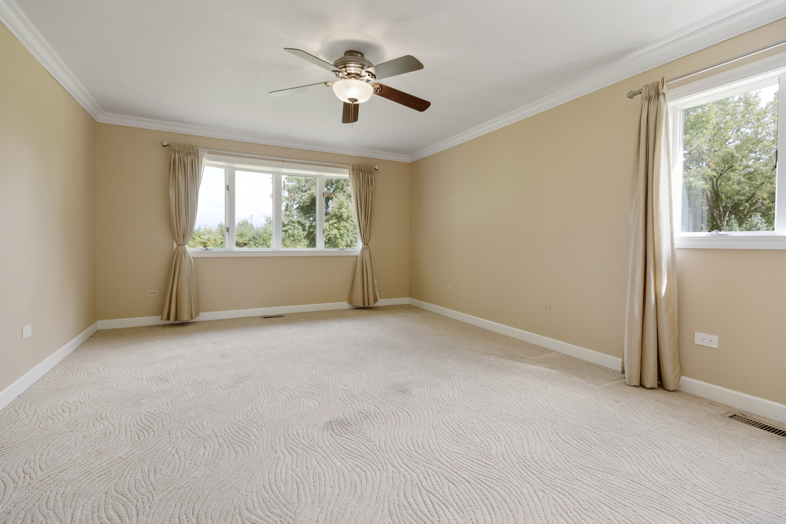 12929 Smith Road Manhattan, IL 60442 - Photo 17 of 41 an empty room with windows chandelier fan and windows