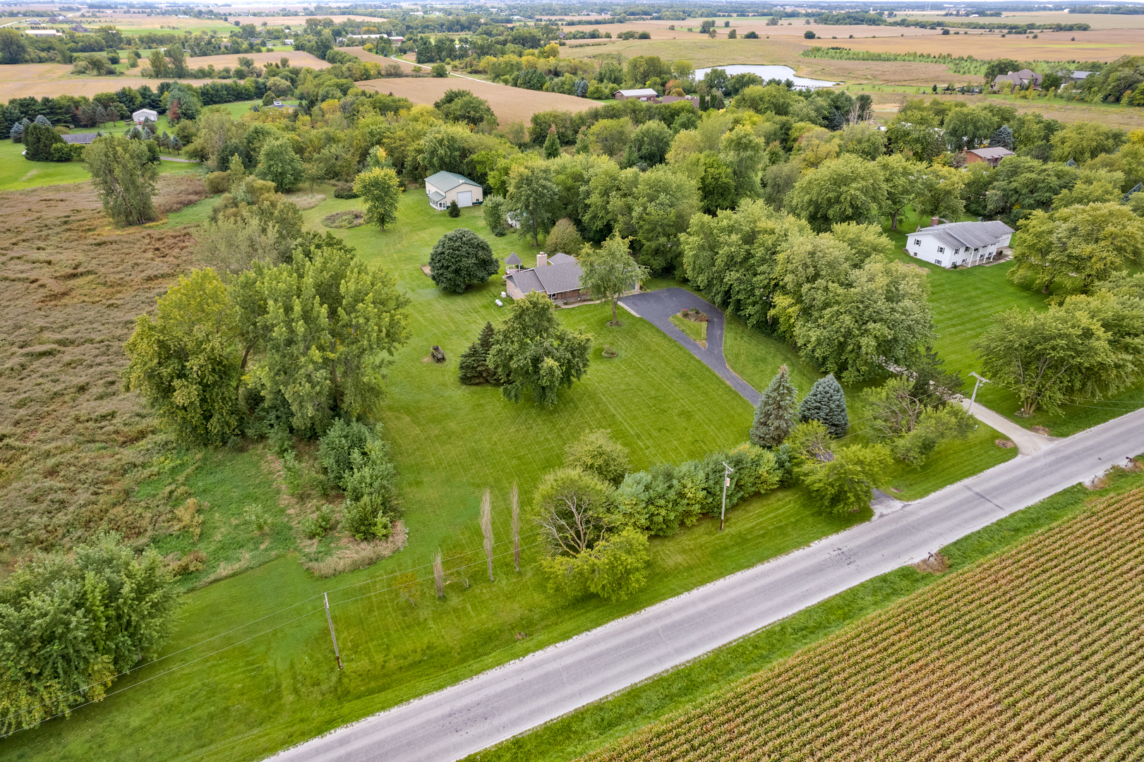12929 Smith Road Manhattan, IL 60442 - Photo 5 of 41 a view of a garden with a lake