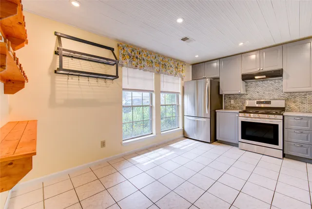 a stove top oven sitting inside of a kitchen