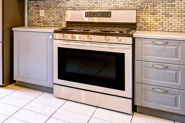 a kitchen with cabinets and appliances