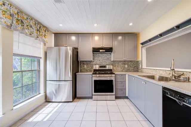 a spacious bathroom with a double vanity sink mirror and shower