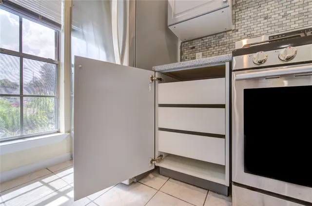 a living room with furniture a fireplace and a large window