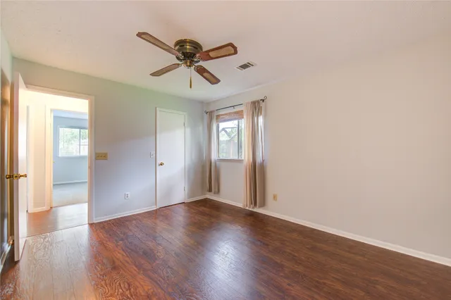 a bathroom with a sink a toilet a mirror and shower
