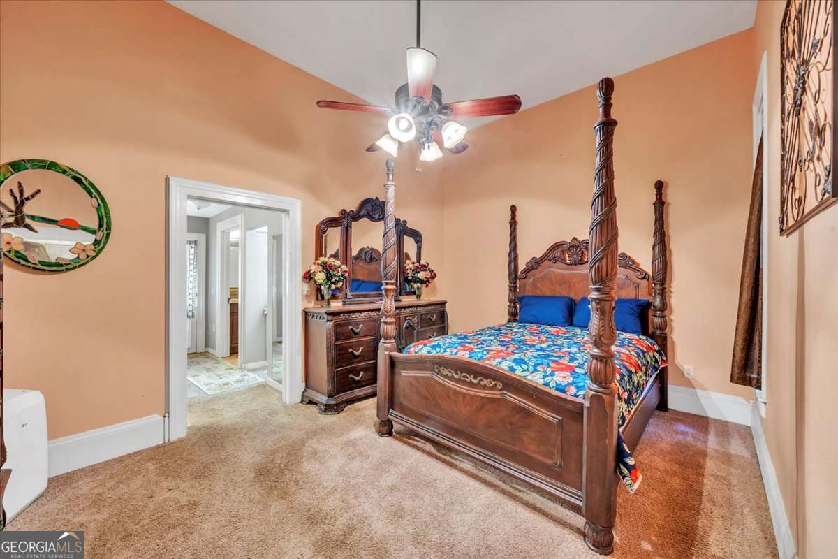 212 East Union Street Vienna, GA 31092 - Photo 25 of 62 a bedroom with furniture and a chandelier