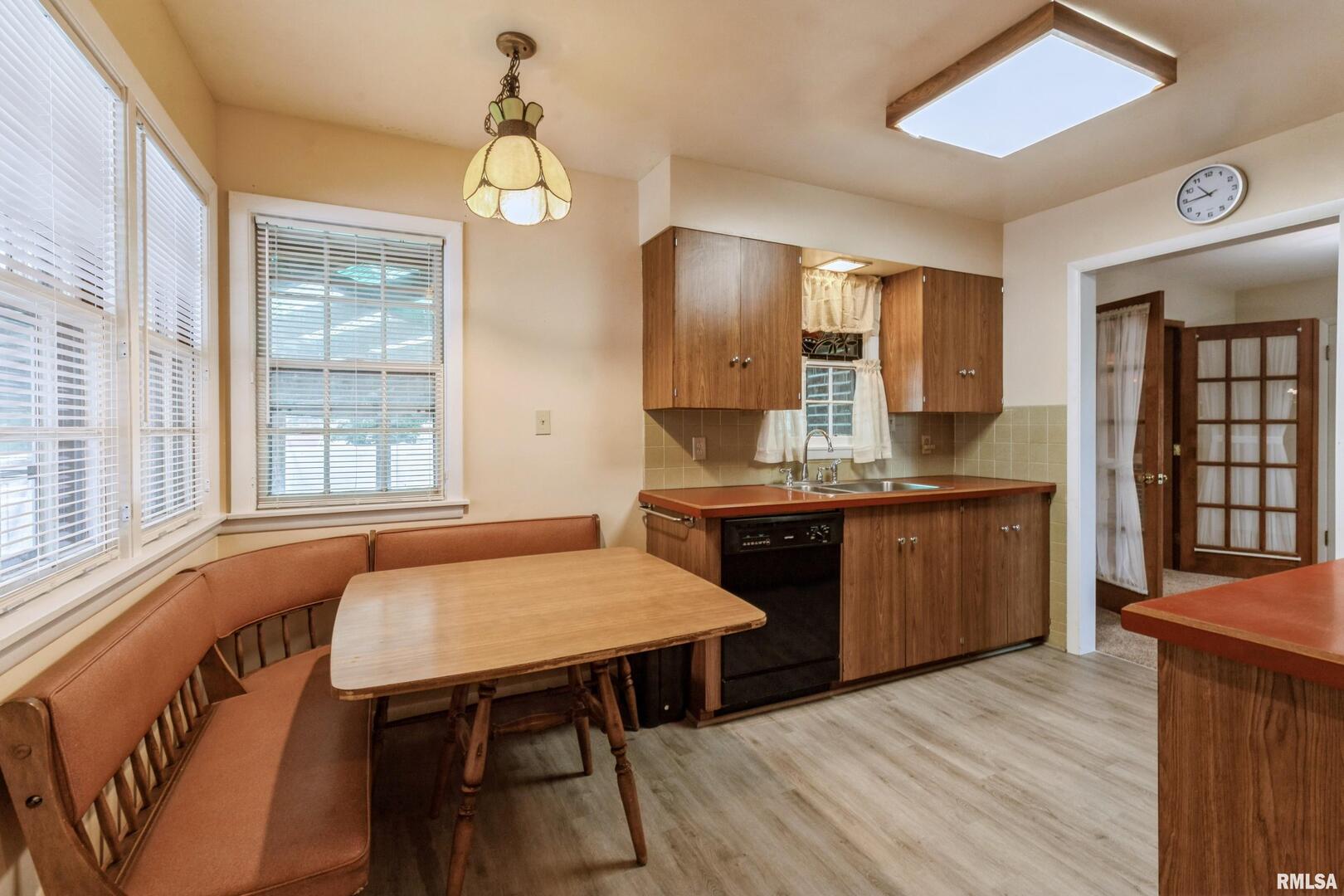 1136 Bobetta Court Clinton, IA 52732 - Photo 15 of 28 a kitchen with a table chairs sink and cabinets
