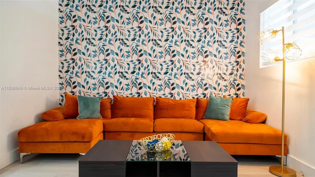 a living room with furniture a table and a potted plant