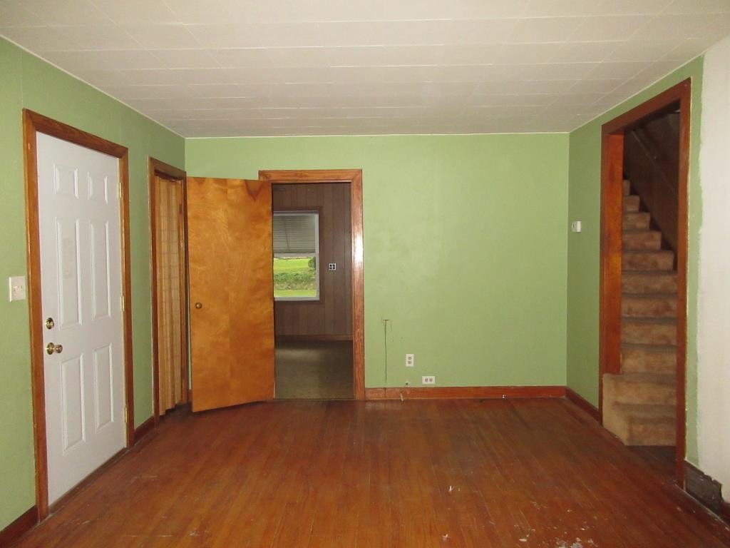 303 Marengo Road Harvard, IL 60033 - Photo 3 of 13 an empty room with closet and wooden floor