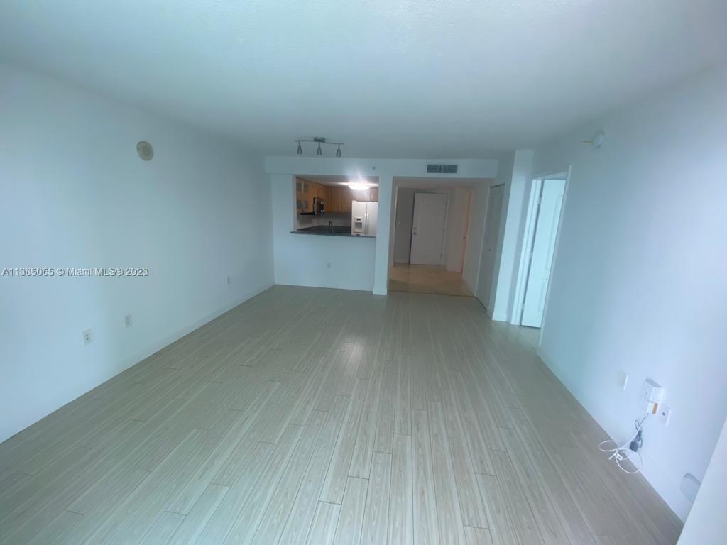 2101 Brickell Avenue, Unit 704 Miami, FL 33129 - Photo 3 of 32 a view of empty room with wooden floor