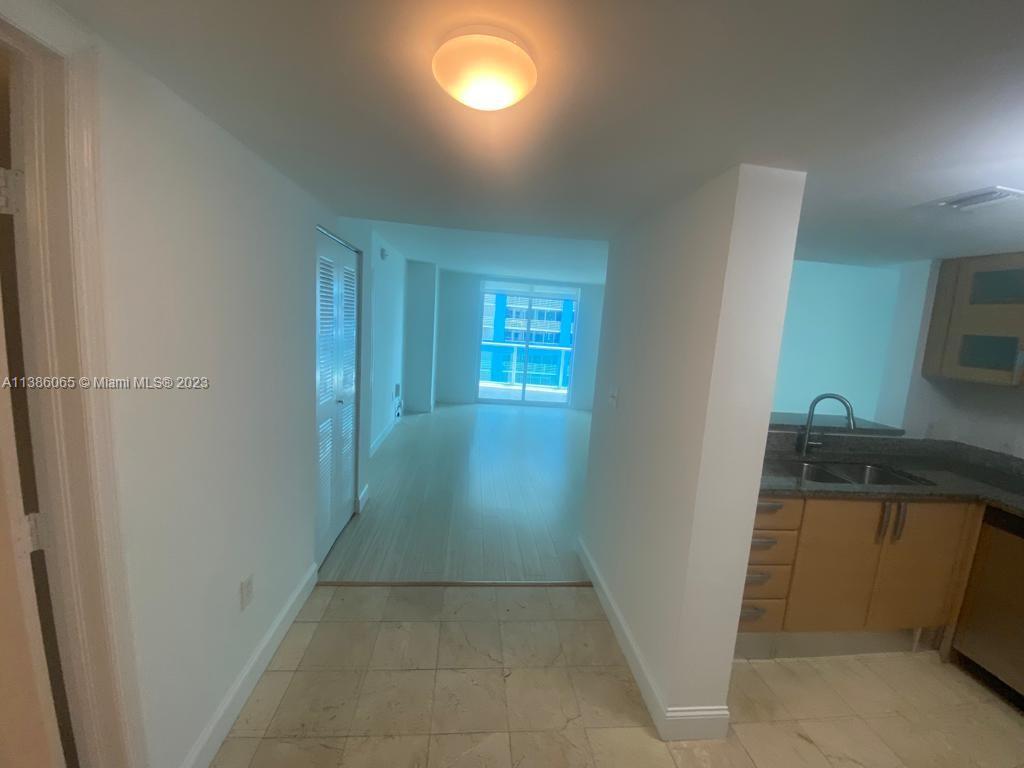 2101 Brickell Avenue, Unit 704 Miami, FL 33129 - Photo 6 of 32 a view of an empty room with a fireplace and a window