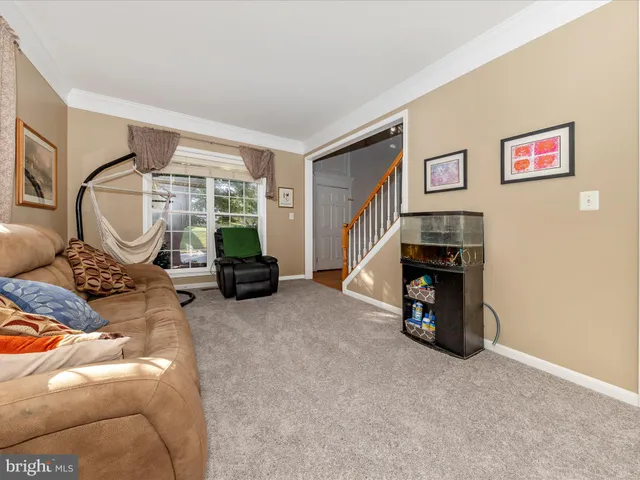 a living room with furniture a window and a fireplace