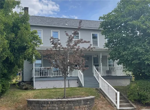 a front view of house with a garden