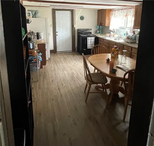 a dining room with furniture and wooden floor