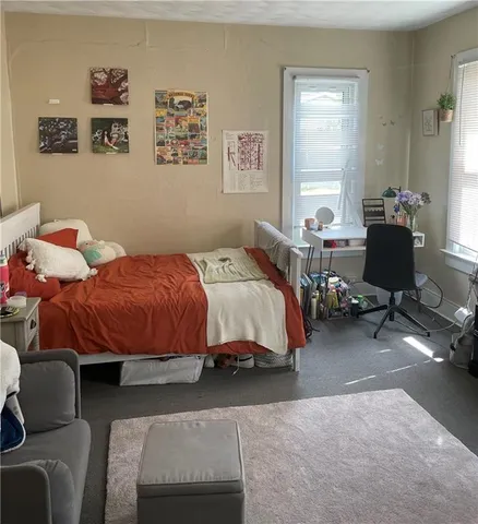 a bedroom with furniture and a window