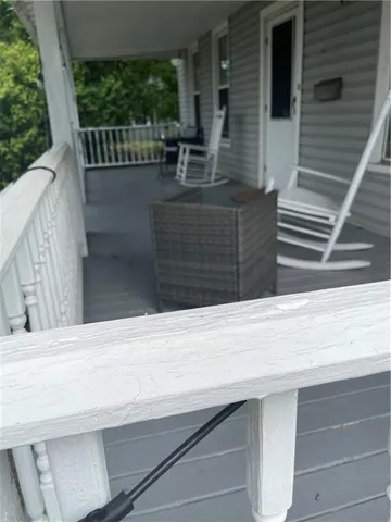 a view of balcony with wooden floor and fence