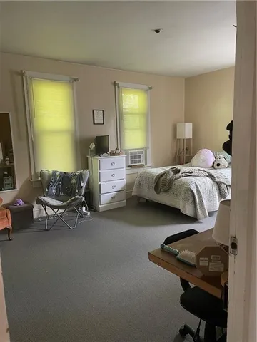a bedroom with a bed and window
